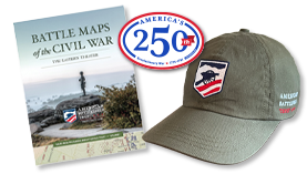 Various magazine covers stacked on top of one another, a baseball hat with an American Battlefield Trust logo and a man wearing a hoodie with an American Battlefield Trust logo design on it.