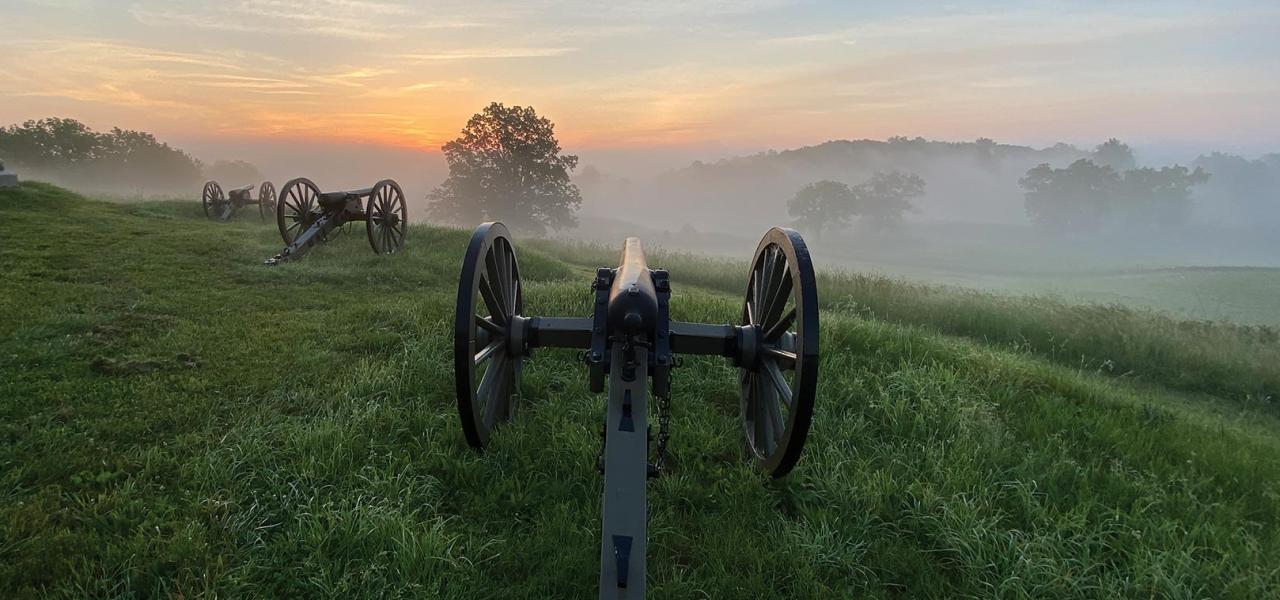 Cannons atop East Cemetery Hill on a misty summer morning.