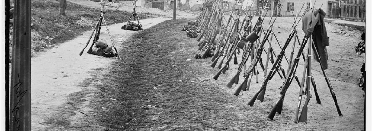 Petersburg, Va. Row of stacked Federal rifles; houses beyond