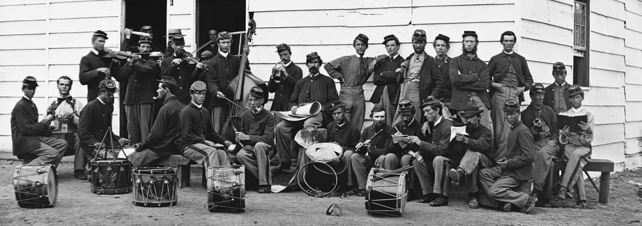 Black and white group photo of soldiers in uniform with drums
