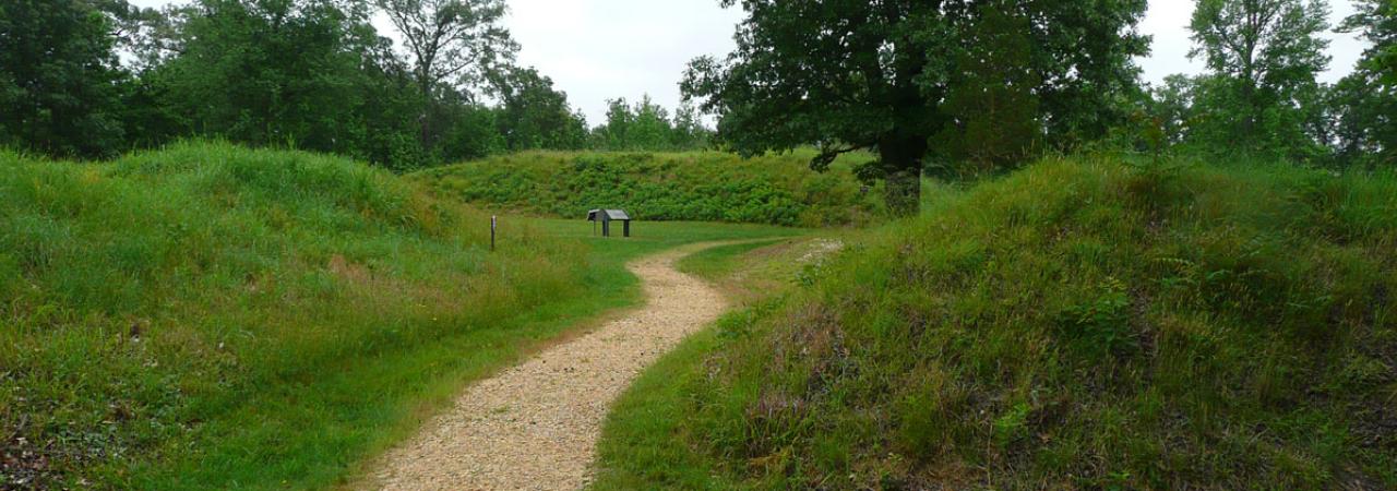 A path leads through Fort Harrison and a marker is seen in the distance.