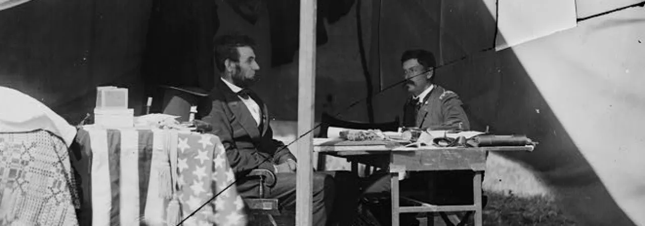Photograph of Lincoln and McClellan seated somewhere at Antietam