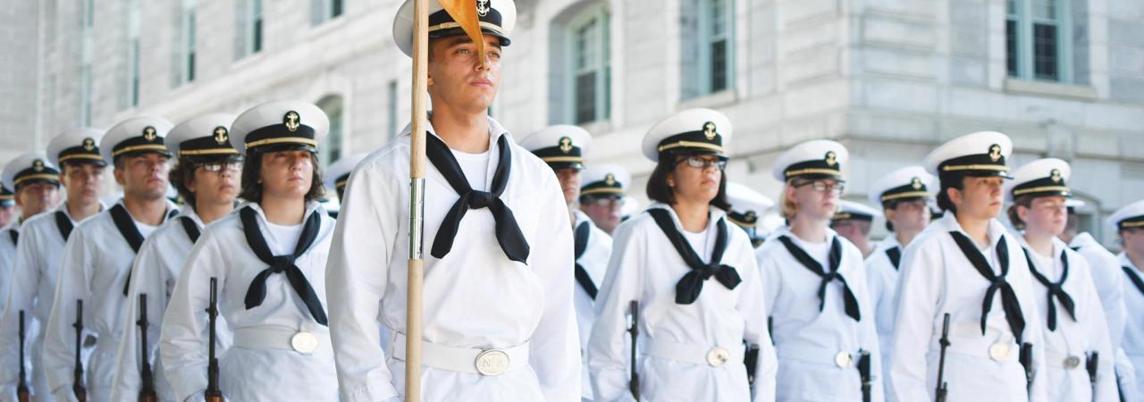 Midshipmen at the Naval Academy in classic navy sailor uniform