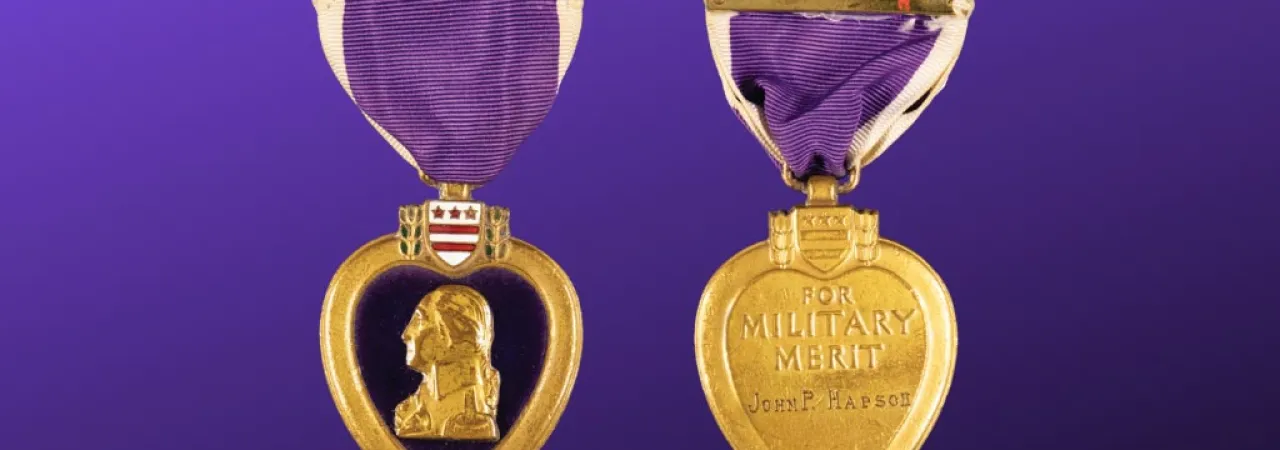 A front and back view of a Purple Heart medal
