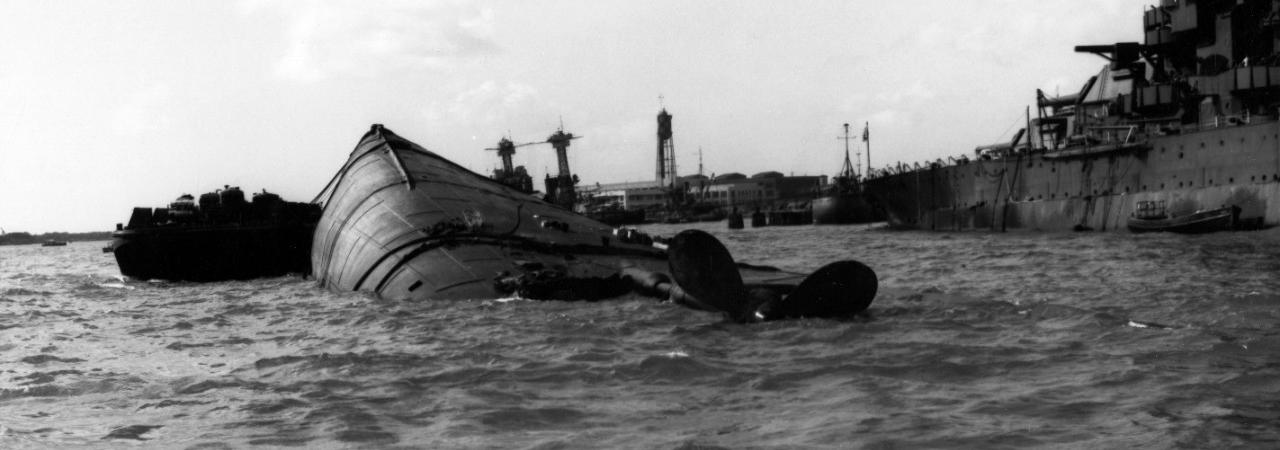 The USS Oklahoma, lying capsized in the harbor following the Japanese attack of December 7, 1941