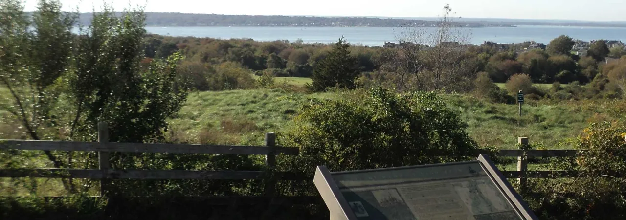 The Narransett Bay, where the French fleet arrived prior to the Battle of Rhose Island, can be seen behind the interpretive marker at Rhode Island Battlefield in Portsmouth, Rhode Island. 