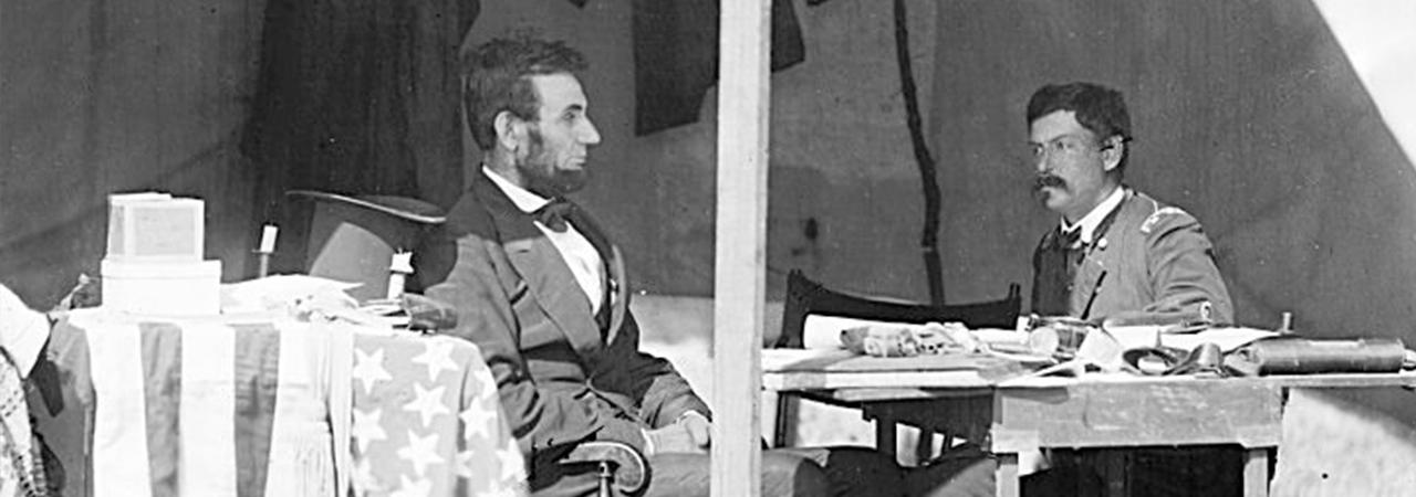 This image depicts Abraham Lincoln sitting and pondering with George McLellan.