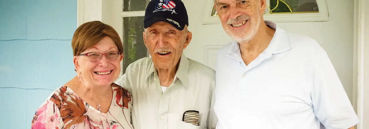 Ed Bearss standing between Dru & Bill Vodra outside his front door
