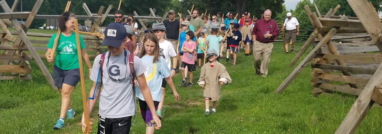 Photograph of a group of children touring a battlefield