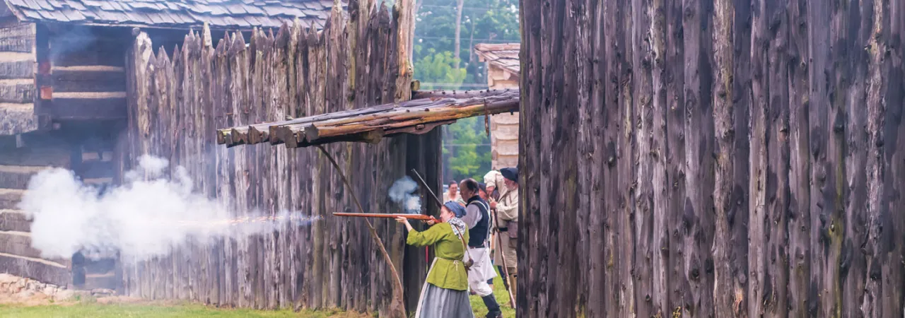 This is an image of a woman firing a gun from Logan's Fort.
