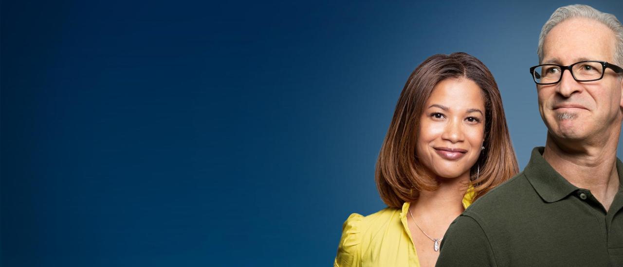 Two teachers stand against a blue gradient background