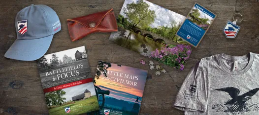 A selection of products sold in the Trust store, including shirts, glasses, books, bags and hats