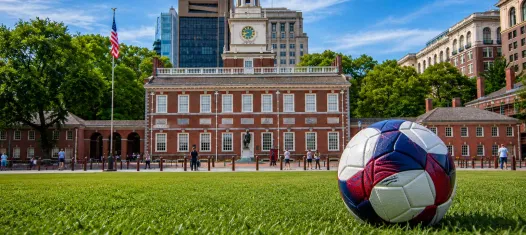 Independence Hall with a red, white, and blue soccer ball
