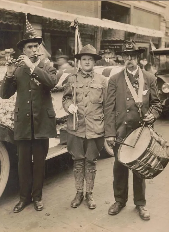 Veterans in the Grand Army of the Republic playing music next to a boy scout in the 1910s, LOC