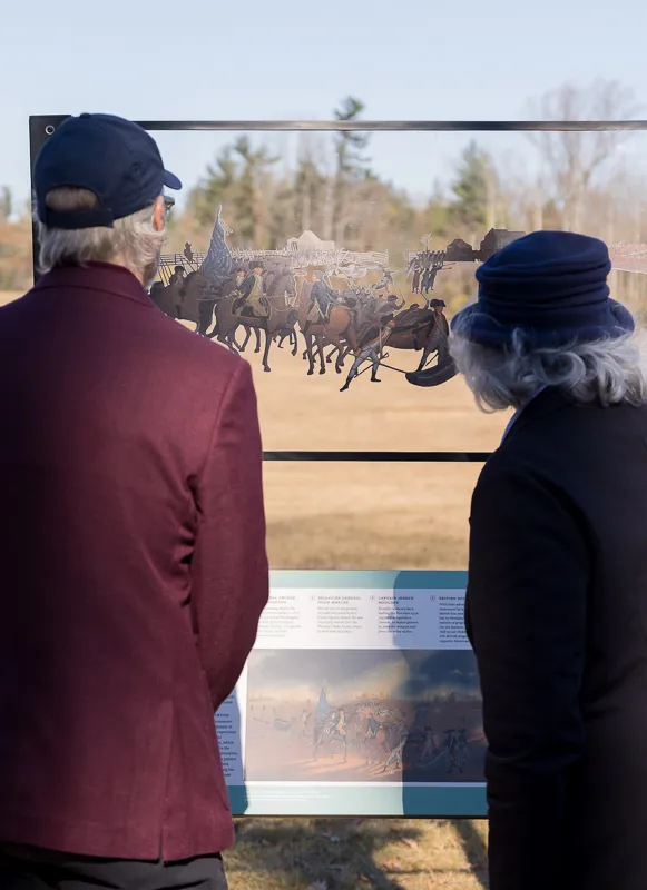 Visitors to Princeton Battlefield State Park peer through new "battle window." 