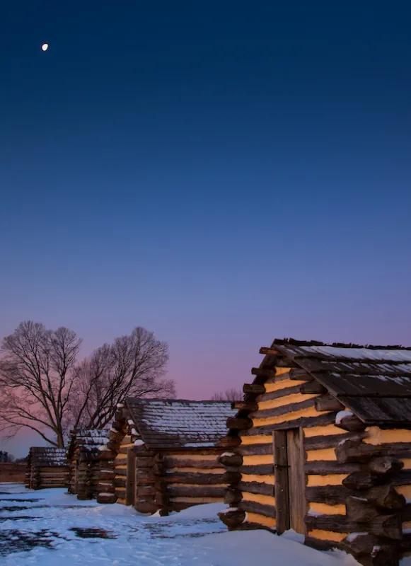 Snow at dawn near the recreated cabins at Valley Forge National Historical Park in King of Prussia, Pa.