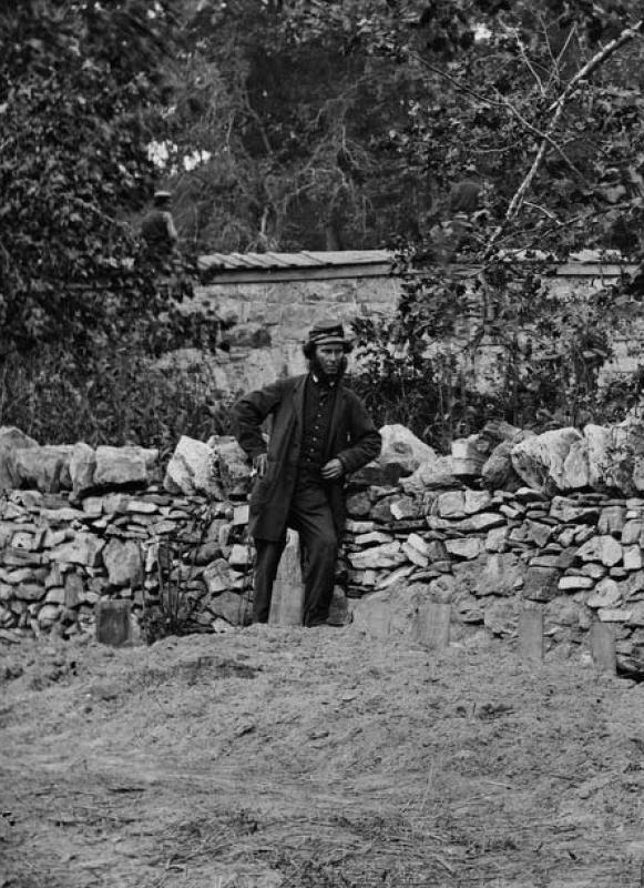 The right portion of a 3-D photo taken by Alexander Gardner labeled “Soldier standing at graves of Federal soldiers, along stone fence, at Burnside Bridge, Antietam, Maryland."