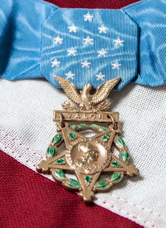 A picture of a Medal of Honor on top of an American flag