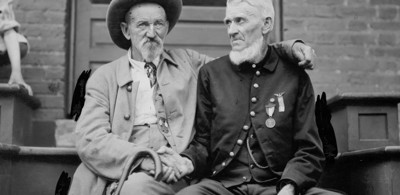 A black and white photo of veterans clasping hands
