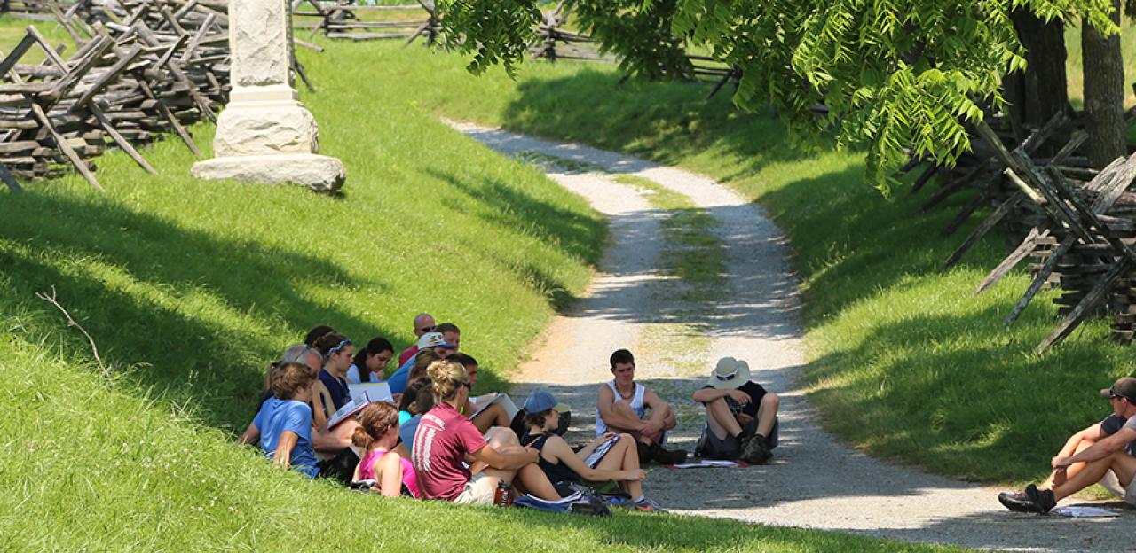 This is an image of a tour group sitting on the Antietam battlefield.