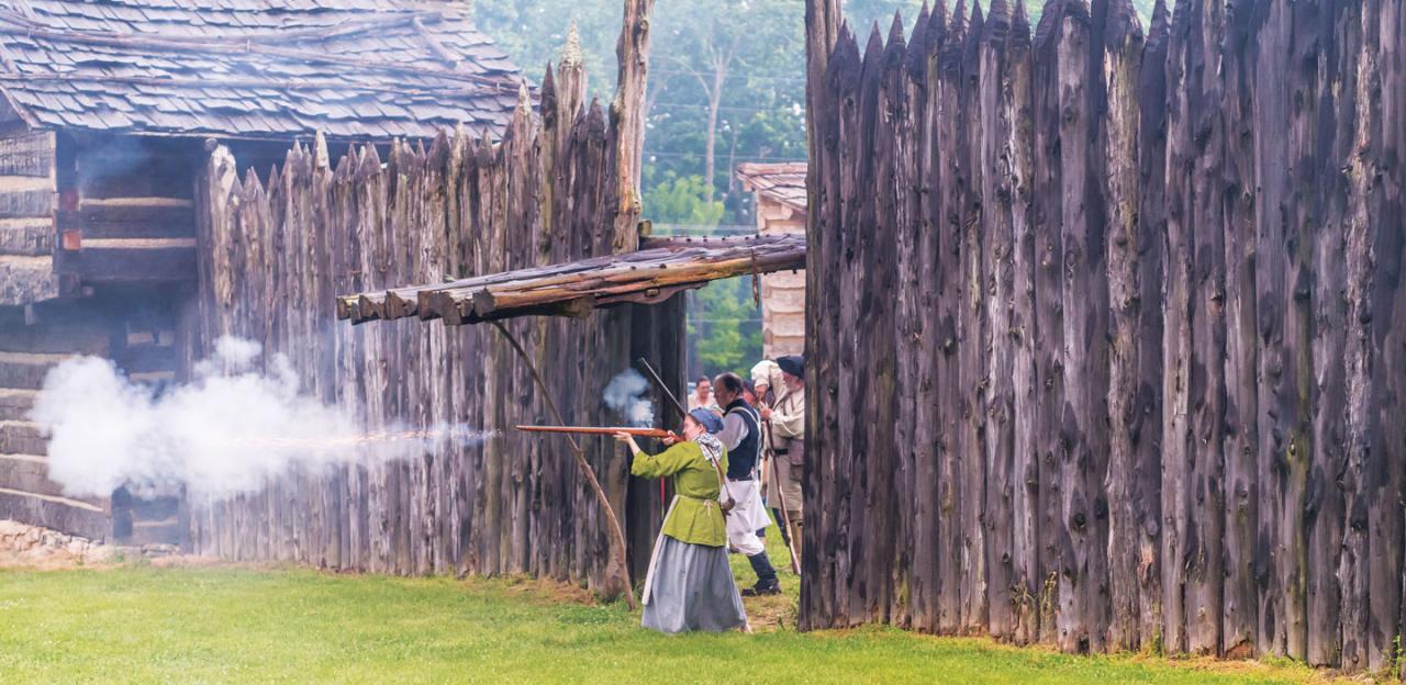 This is an image of a woman firing a gun from Logan's Fort.