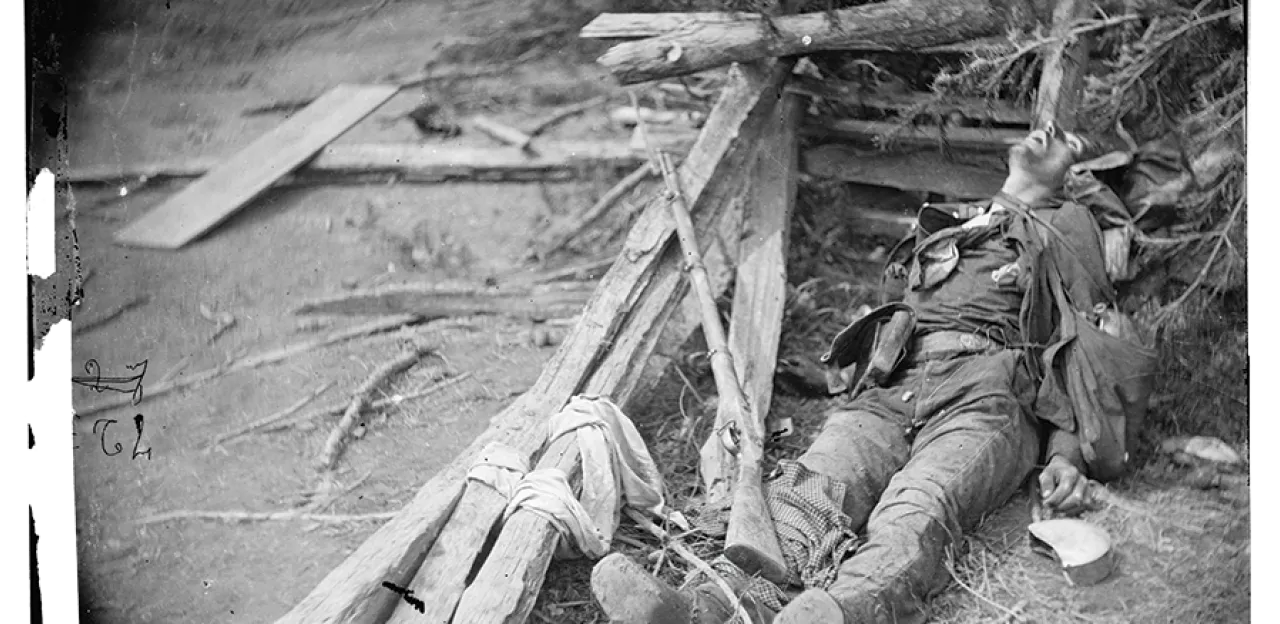 This photograph shows a soldier lying dead in the rubble of Spotsylvania.