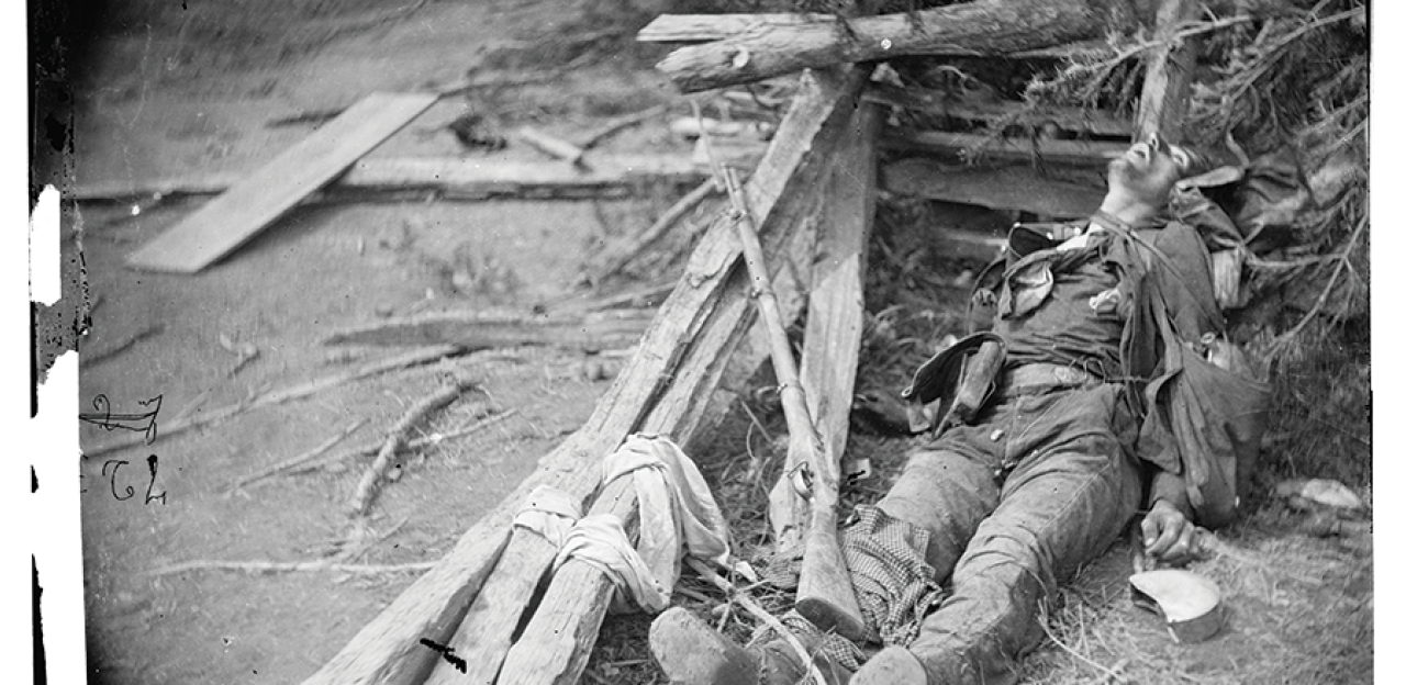 This photograph shows a soldier lying dead in the rubble of Spotsylvania. 