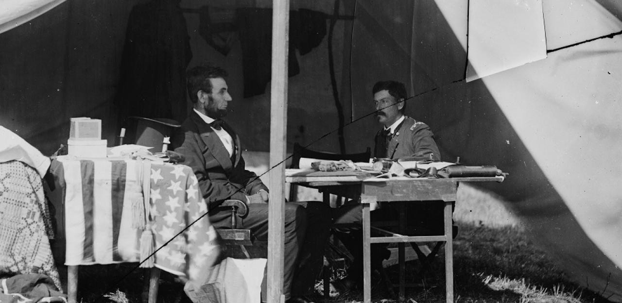 Photograph of McClellan discussing business in a tent