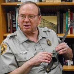 Portrait of historian holding a Civil War sword