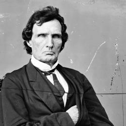 Black-and-white image of a man in a western suit. 