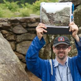 Photo of Gary Adelman holding up an image