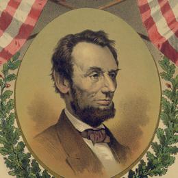 A portrait of Abraham Lincoln bordered by two American flags