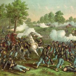 Colorful historical lithograph depicting the Battle of Wilson's Creek on August 10, 1861. Union and Confederate infantry clash across an open battlefield amid smoke, artillery fire, and mounted officers directing troops, with General Nathaniel Lyon prominently leading the Union attack.