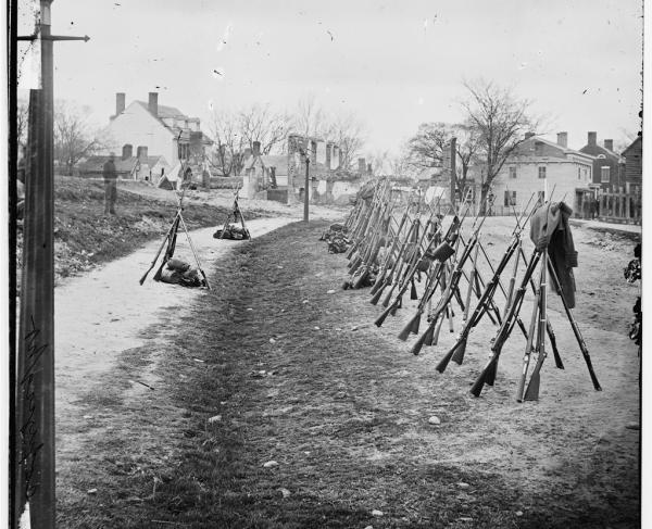 Petersburg, Va. Row of stacked Federal rifles; houses beyond