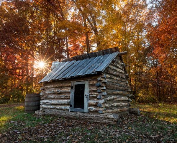 Replica civil war quarters with an Autumn backdrop at Bristoe Station Battlefield in Bristow, VA.