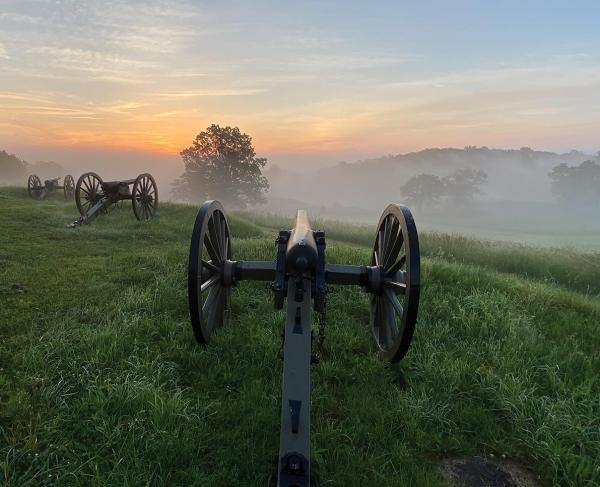 Cannons atop East Cemetery Hill on a misty summer morning.