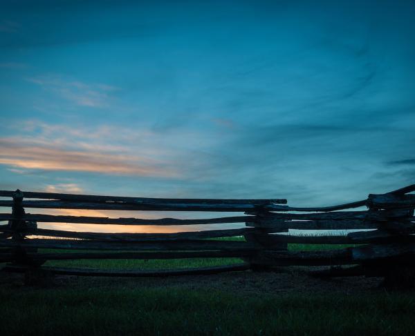 Split rail fence at sunset