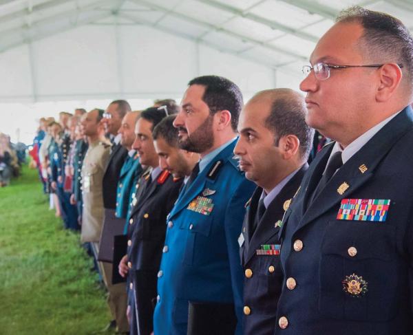 Officers standing in rows at a National Defense University graduation ceremony