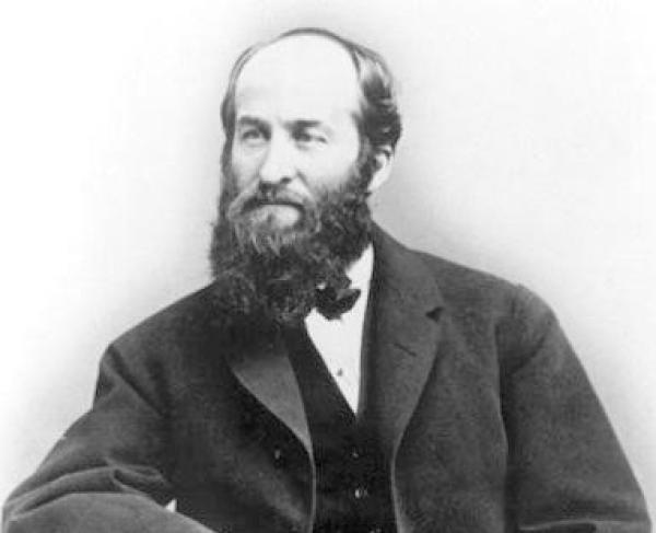 Photograph portrait of a man with a beard in a suit