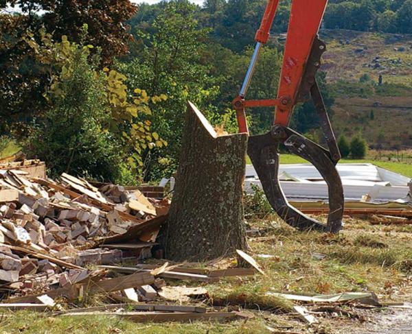 A lift clears rubble at a Trust restoration project in Gettyburg, Pa.  Little round Top is seen in the background.