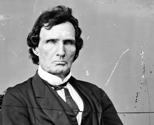 Black-and-white image of a man in a western suit. 