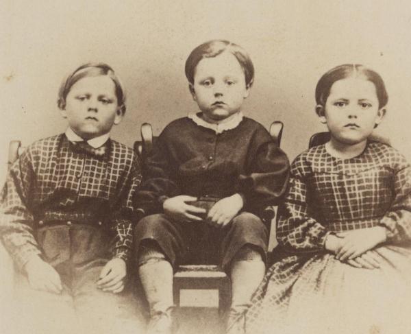 A photograph of three children labeled Frank, Frederick and Alice