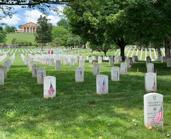 Grave markers with flags at Arlington National Cemetery
