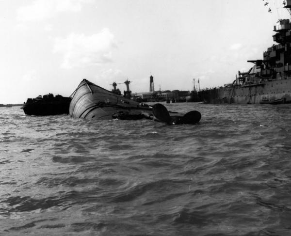 The USS Oklahoma, lying capsized in the harbor following the Japanese attack of December 7, 1941