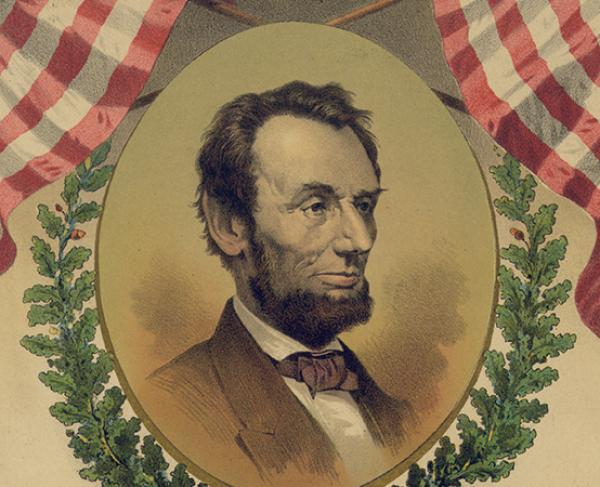 A portrait of Abraham Lincoln bordered by two American flags