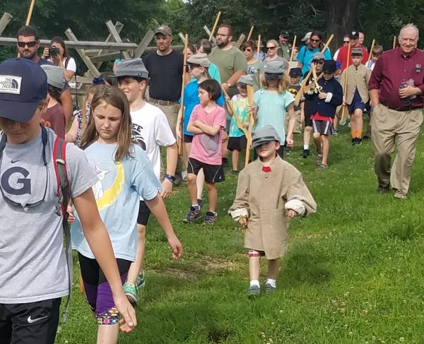 Photograph of a group of children touring a battlefield