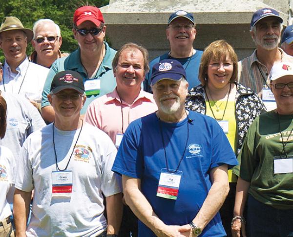Group of Trust members on a tour pose for a photo