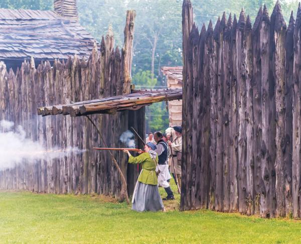 This is an image of a woman firing a gun from Logan's Fort. 
