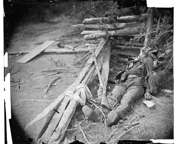 This photograph shows a soldier lying dead in the rubble of Spotsylvania. 