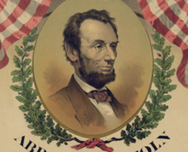 A portrait of Abraham Lincoln bordered by two American flags